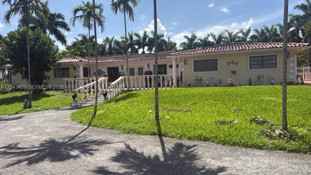 A single-story house with a tiled roof, white balustrade stairs, and a large front lawn — 4000 SW 126th Ave, Miramar FL 33027, MIRAMAR, FL