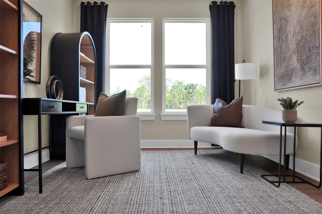 A home office features a desk, an armchair, a curved sofa, and two large windows — 81 LAKE MANATEE DRIVE, PALM COAST, FL