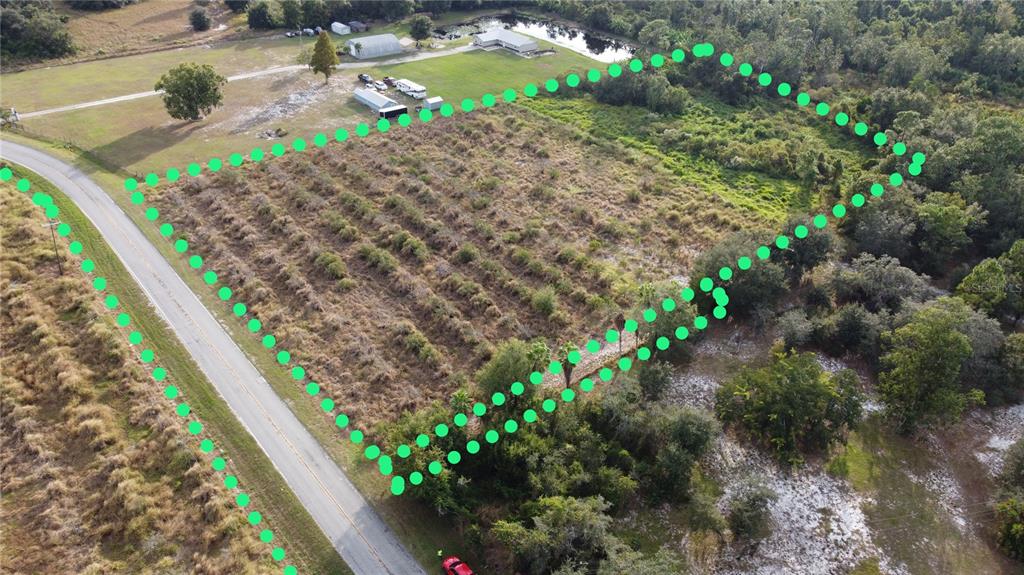 An aerial view shows a vacant, rectangular plot of land outlined with green dots — 7630 LAKE BUFFUM ROAD N, FORT MEADE, FL