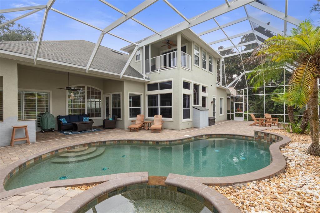 A two-story house with a screened-in pool, spa, and patio area — 10 N VILLAGE PARKWAY, PALM COAST, FL