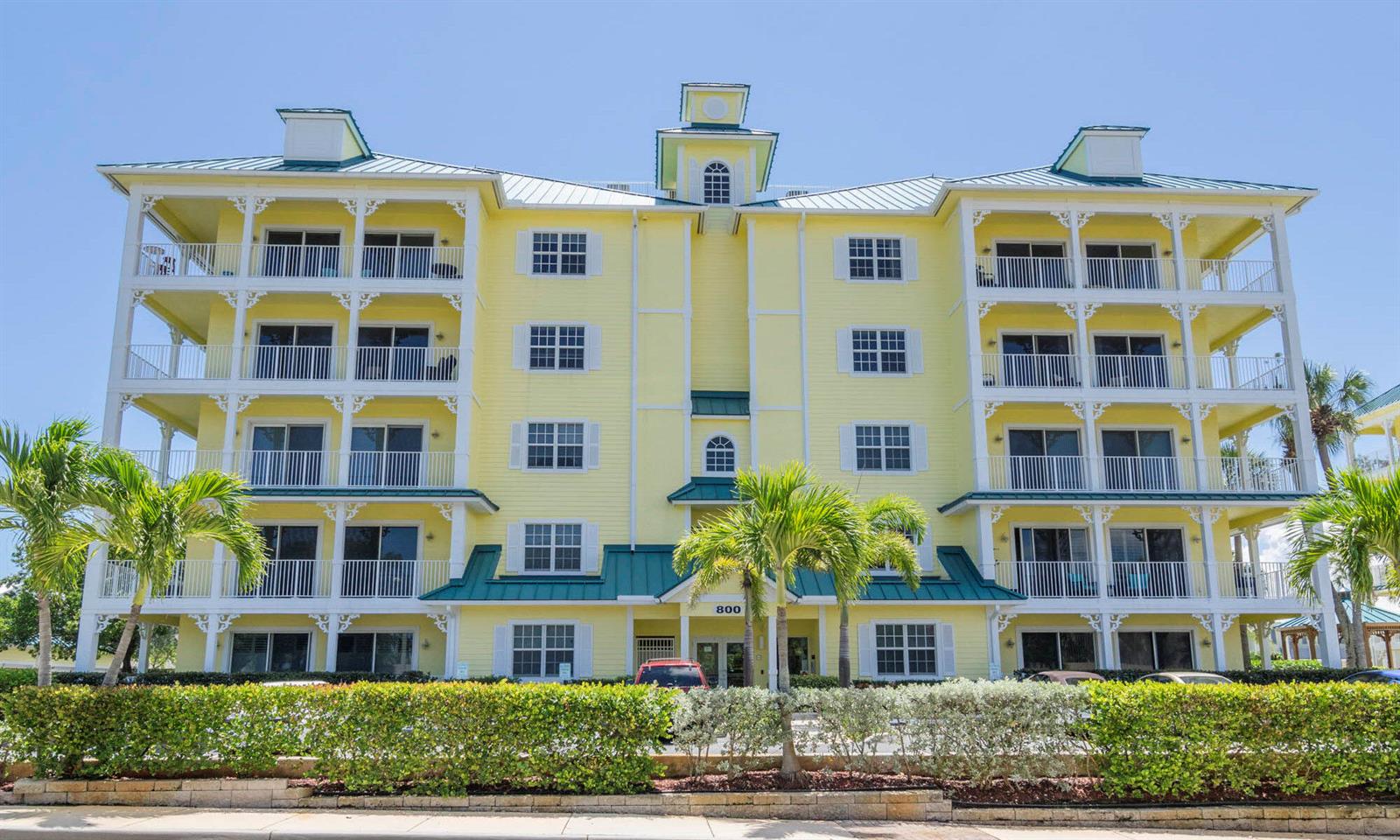 A four-story yellow building with white balconies and a green metal roof — 800 Juno Ocean Walk # 304, Juno Beach FL 33408, JUNO BEACH, FL