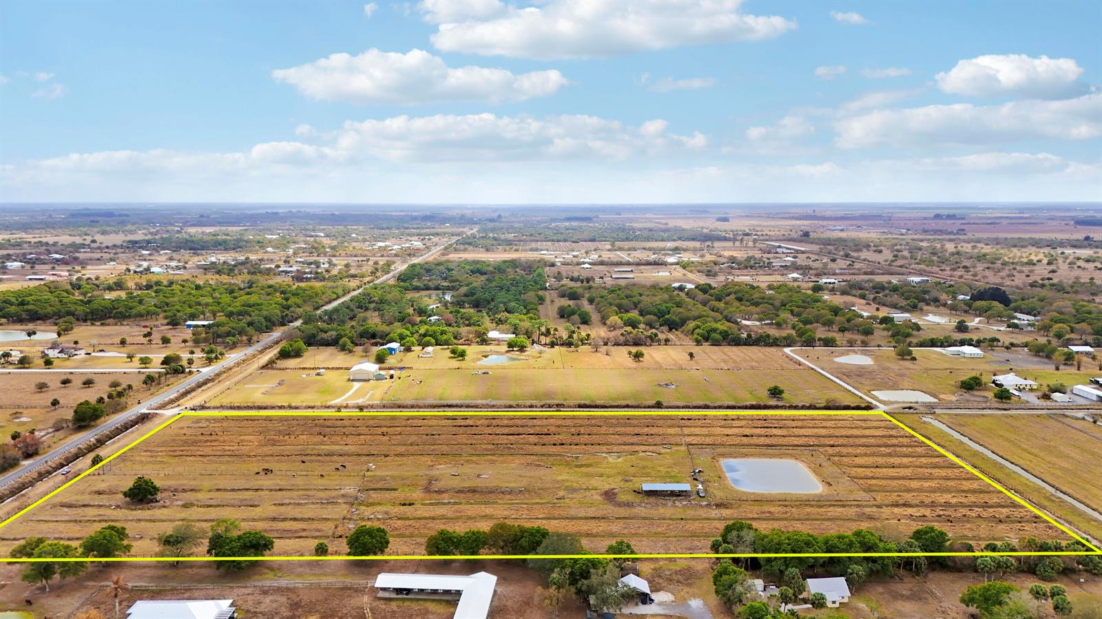 An aerial view shows a large, rectangular fenced pasture with a small pond and shed — Tbd S Brocksmith Road, Fort Pierce FL 34945, FORT PIERCE, FL