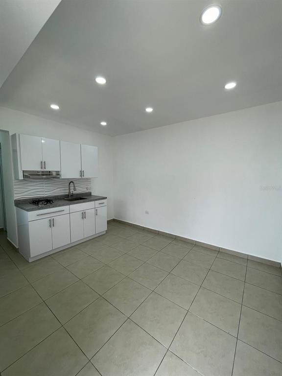 A small kitchen area features white cabinets, a gray countertop, and light-colored floor tiles — CARR 416 INT CALLE C UNIT 1, AGUADA, PR