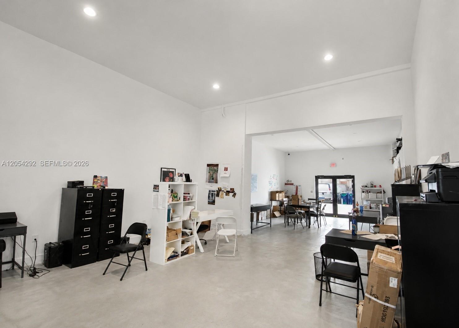 An open-plan office space features white walls, recessed lighting, and a concrete floor — 7000 NW 2 Ave # 7060, Miami FL 33150, MIAMI, FL