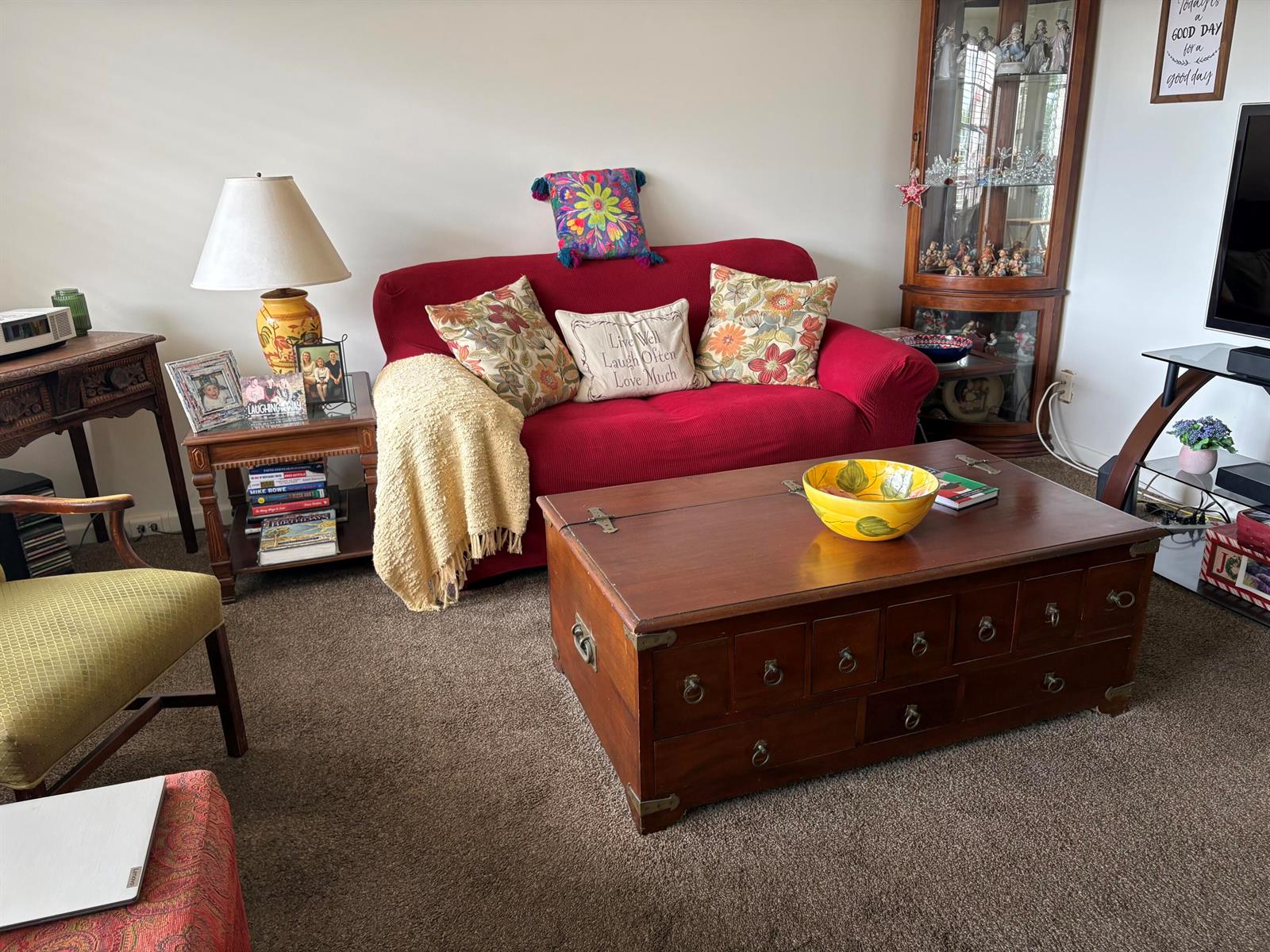 A living room features a red sofa, a wooden trunk coffee table, and a display cabinet — 314 Preston H, Boca Raton FL 33434, BOCA RATON, FL
