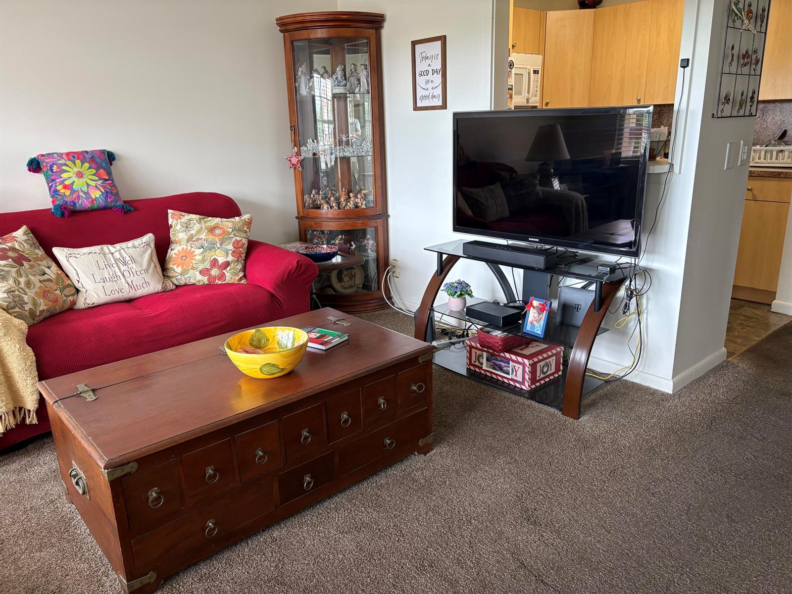 A living room features a red sofa, a wooden coffee table, and a television stand — 314 Preston H, Boca Raton FL 33434, BOCA RATON, FL