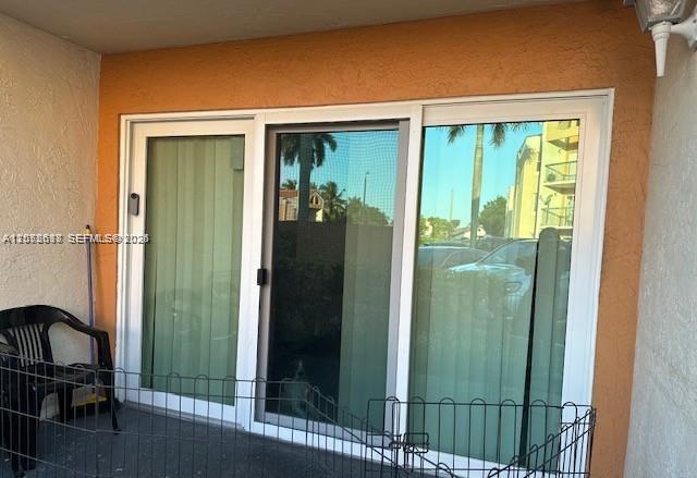 A sliding glass door leads to a patio area with a black metal pet fence — 6288 NW 186th St # 112, Hialeah FL 33015, HIALEAH, FL