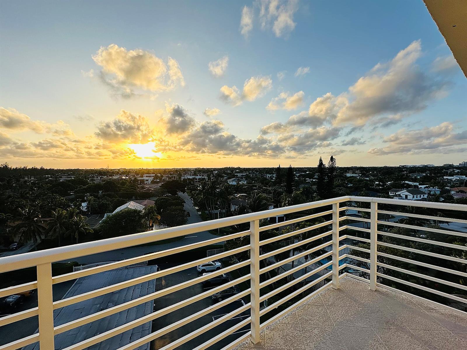 A balcony with a white metal railing overlooks a suburban neighborhood at sunset — 2851 S Ocean Boulevard # 7s, Boca Raton FL 33432, BOCA RATON, FL