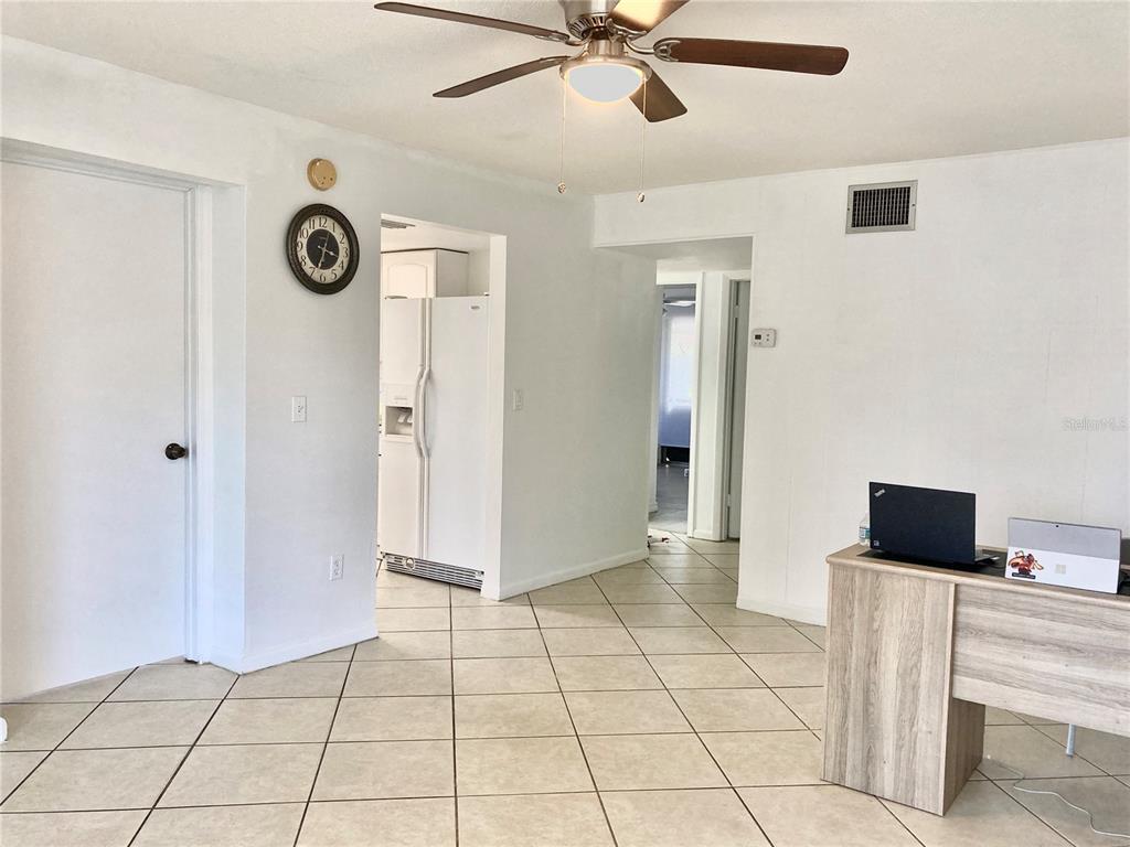 A room with tiled floors, a ceiling fan, a wall clock, and a desk — 3319 SHERWOOD DRIVE, LARGO, FL
