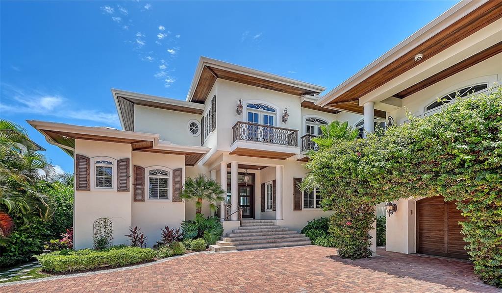 A two-story house with a brick driveway, a balcony, and a covered garage entrance — 1435 WESTWAY DRIVE, SARASOTA, FL