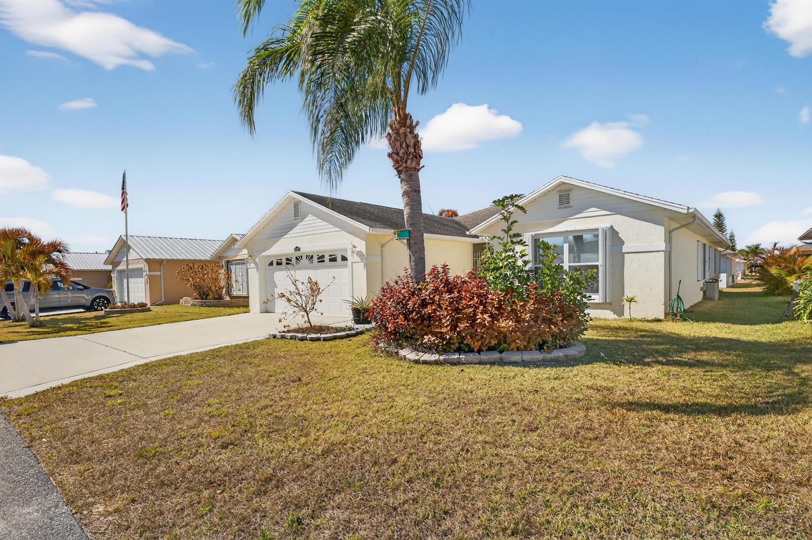 A single-story house with a palm tree, a front garden, and a concrete driveway — 6737 Campanilla, Fort Pierce FL 34951, FORT PIERCE, FL