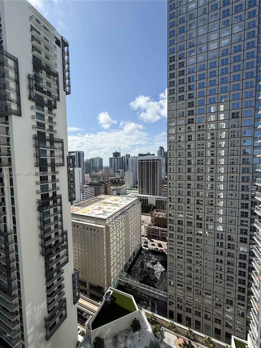 An elevated view shows a city skyline framed by two tall, modern glass skyscrapers — 300 S Biscayne Blvd # 2903, Miami FL 33131, MIAMI, FL