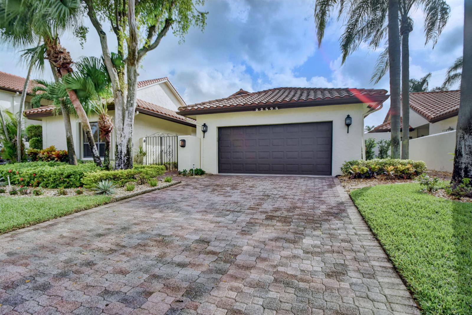 A single-story house with a brown garage door, tiled roof, and a paved driveway — 22595 Esplanada Circle W, Boca Raton FL 33433, BOCA RATON, FL