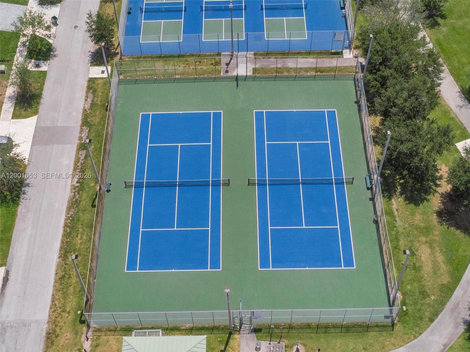 An aerial view shows two blue tennis courts surrounded by a chain-link fence — 7830 SW 199th Ter, Cutler Bay FL 33189, CUTLER BAY, FL