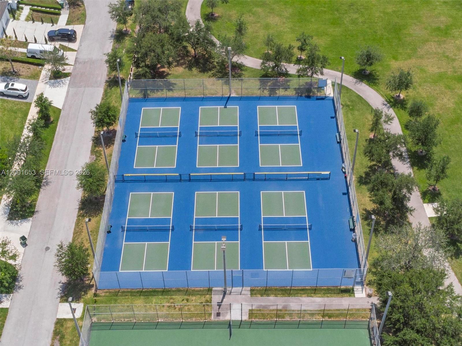 An aerial view shows six blue pickleball courts enclosed by a chain-link fence — 7830 SW 199th Ter, Cutler Bay FL 33189, CUTLER BAY, FL