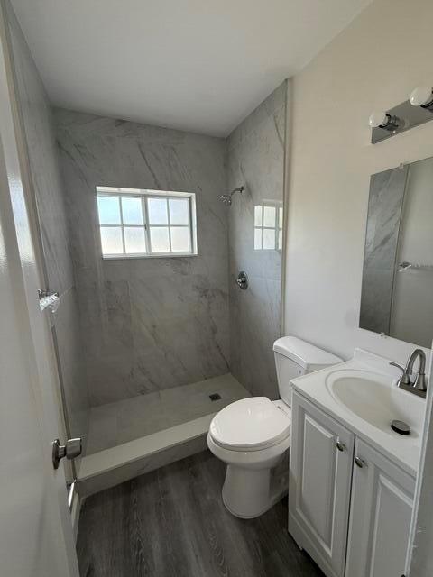 A bathroom features a walk-in shower with marble-look tile, a white vanity, and gray flooring — 2802 SW 36th Avenue, Miami FL 33133, MIAMI, FL