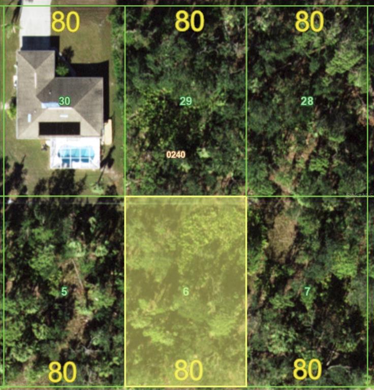 This aerial map shows a highlighted vacant lot surrounded by adjacent residential properties and vegetation — 18360 BLANCHE AVENUE, PORT CHARLOTTE, FL