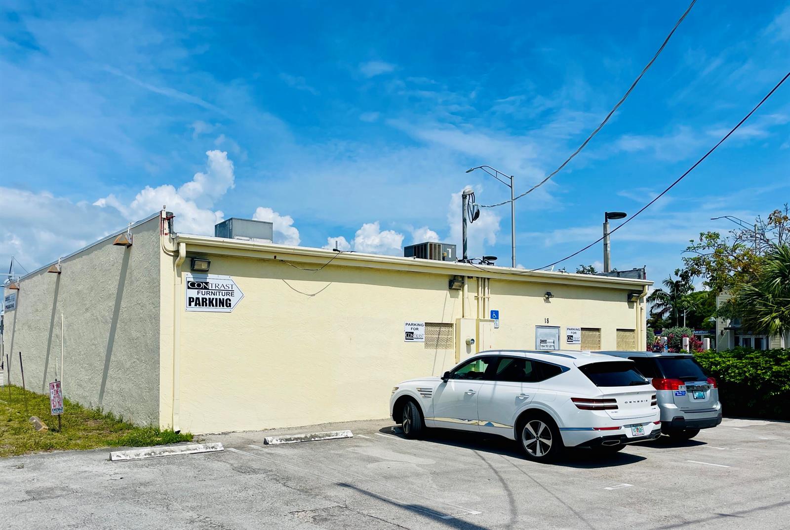 A white SUV is parked in front of a yellow commercial building with parking signage — 18 S Federal Highway, Pompano Beach FL 33062, POMPANO BEACH, FL