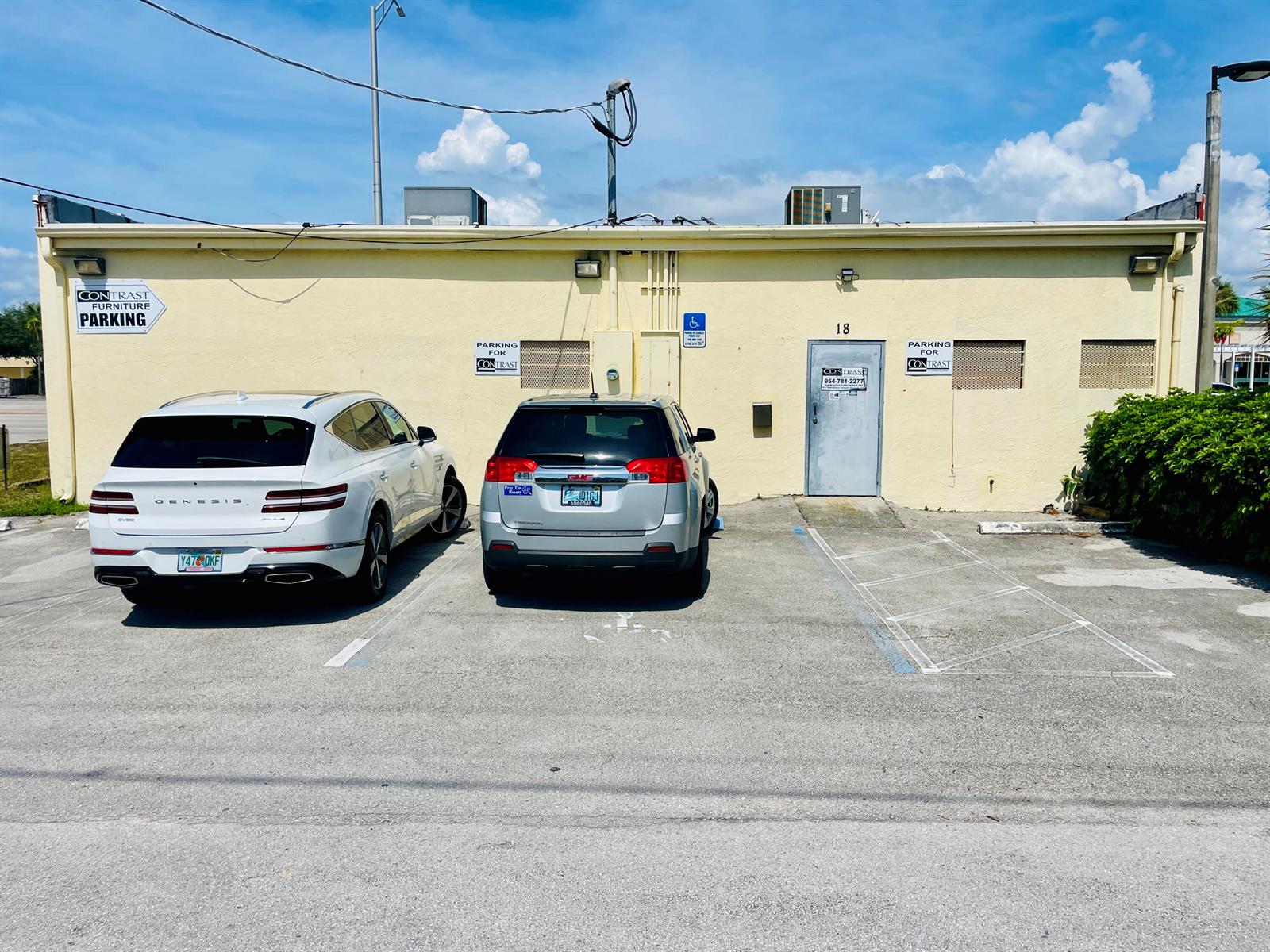 A yellow commercial building exterior with two parked cars and designated parking signs — 18 S Federal Highway, Pompano Beach FL 33062, POMPANO BEACH, FL