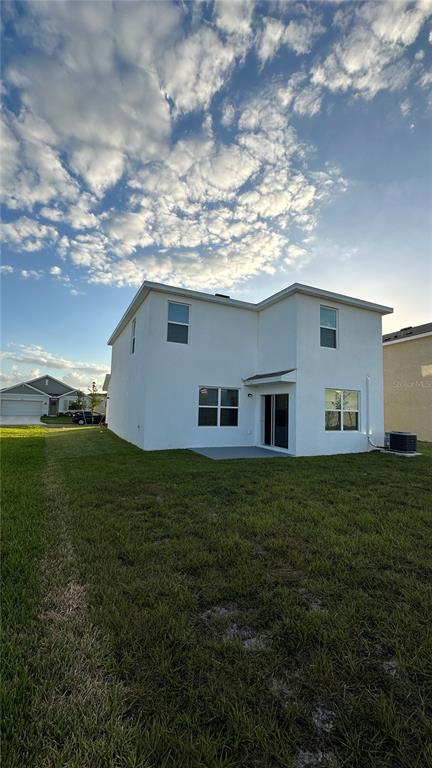 A two-story white stucco house with a two-car garage and a green lawn — 33503 ELM HILL BRANCH, WESLEY CHAPEL, FL