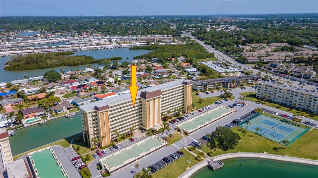 An aerial view shows a multi-story apartment building with a yellow arrow pointing to a unit — 4725 COVE CIRCLE UNIT 804, ST PETERSBURG, FL