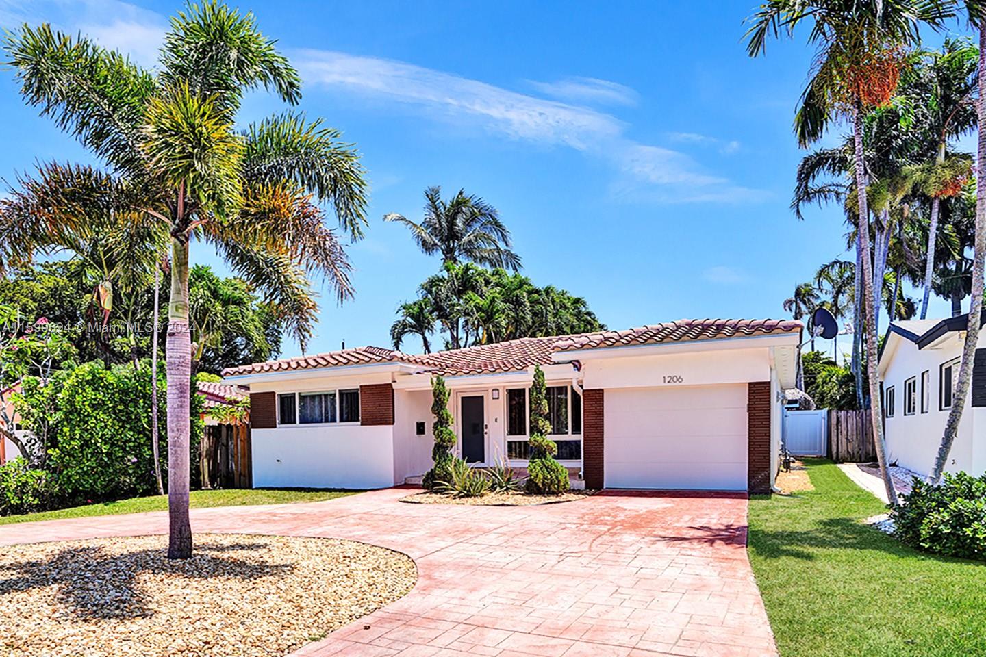 A single-story house with a white exterior, brown brick accents, and a tiled roof — 1206 Lincoln St, Hollywood FL 33019, HOLLYWOOD, FL