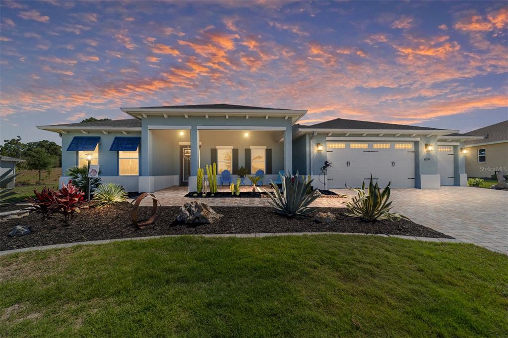 A single-story house with a blue exterior, a covered front porch, and a paved driveway — 10298 SW 96TH LOOP, OCALA, FL