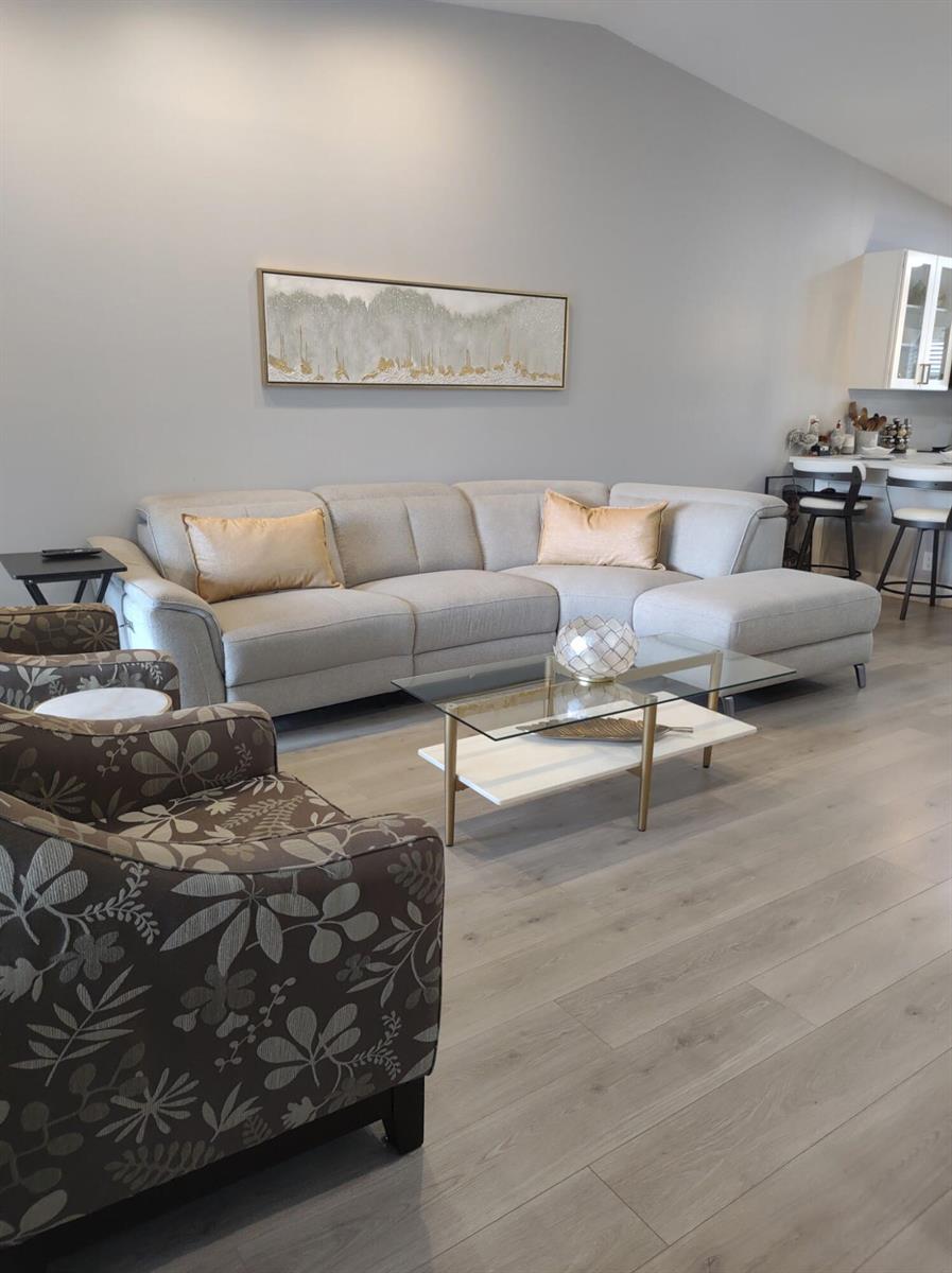 A living room features a light gray sectional sofa, patterned armchairs, and a glass coffee table — 18768 Argosy Drive, Boca Raton FL 33496, BOCA RATON, FL