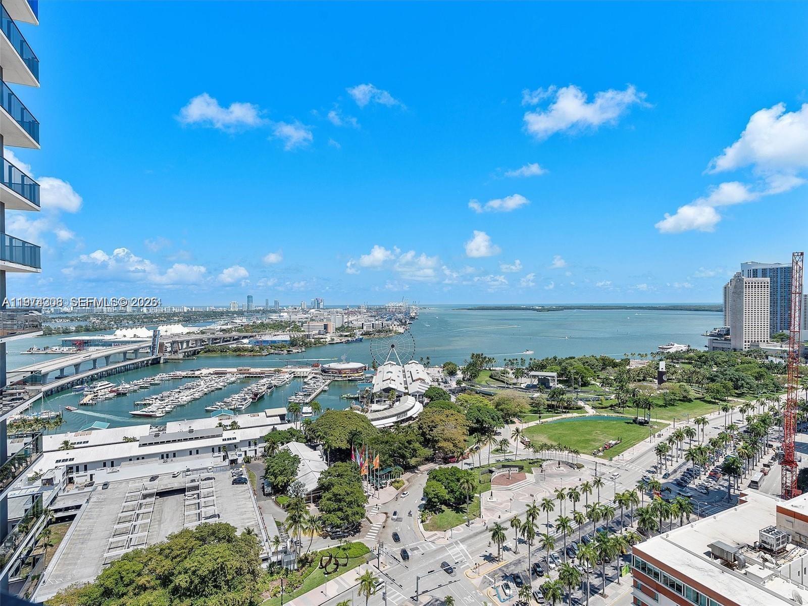An elevated view of a marina, park, and city skyline under a clear blue sky — 398 NE 5th St # 1915, Miami FL 33132, MIAMI, FL