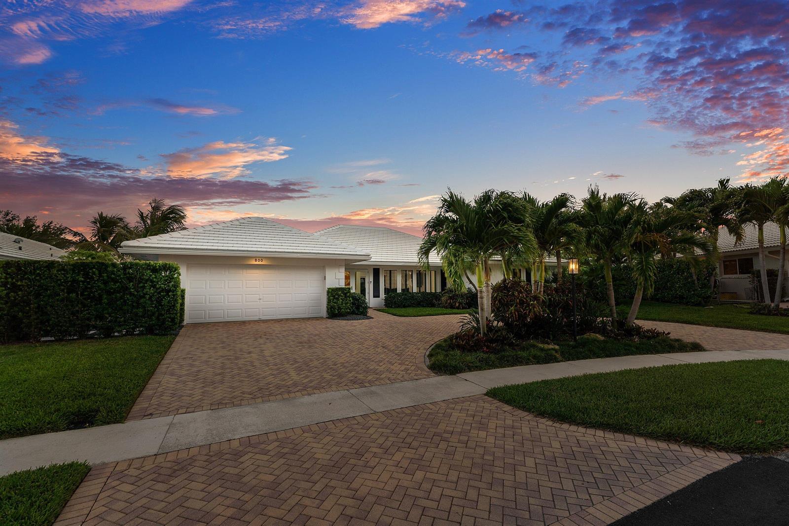 A single-story house with a white tile roof and a paved driveway at sunset — 800 Holly Lane, Boca Raton FL 33486, BOCA RATON, FL