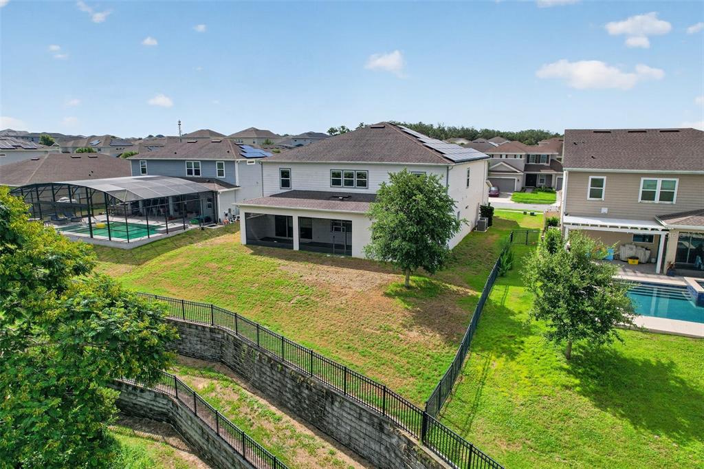 An aerial view shows the rear exterior of a two-story house with a screened patio — 3399 BUOY CIRCLE, WINTER GARDEN, FL