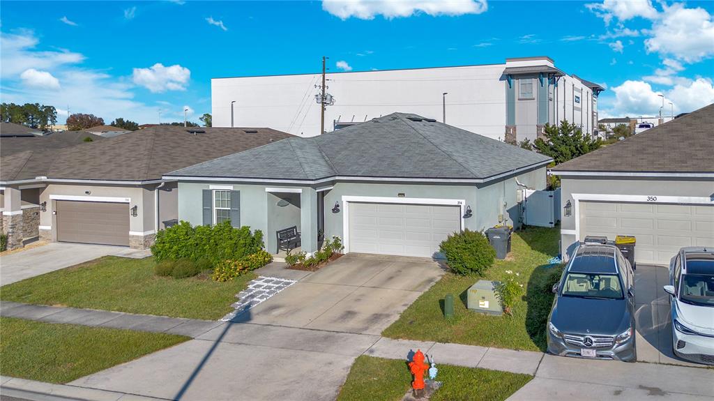 A single-story house with a gray roof, light green exterior, and a two-car garage — 354 CASA VERANO LANE, DAVENPORT, FL