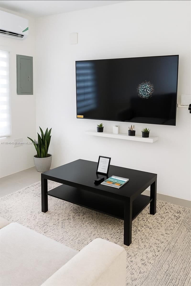 A living room features a wall-mounted television, a floating shelf, and a black coffee table — 00 Norbrook, Kingston, Jamaica # 1, NA, NA