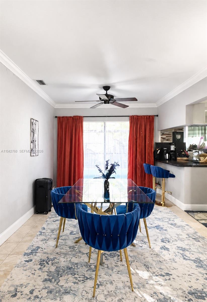 A dining area features a glass table, blue velvet chairs, and red curtains — 2450 NW 85th Ave, Sunrise FL 33322, SUNRISE, FL