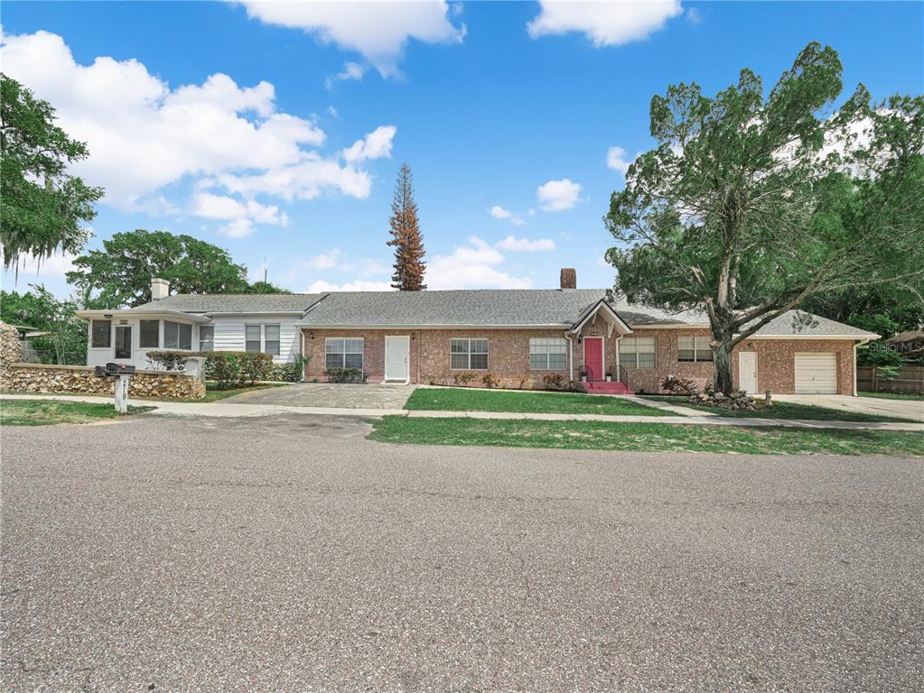 A single-story brick and white siding house with a garage and a large front lawn — 221 CITRUS GROVE BOULEVARD S, POLK CITY, FL