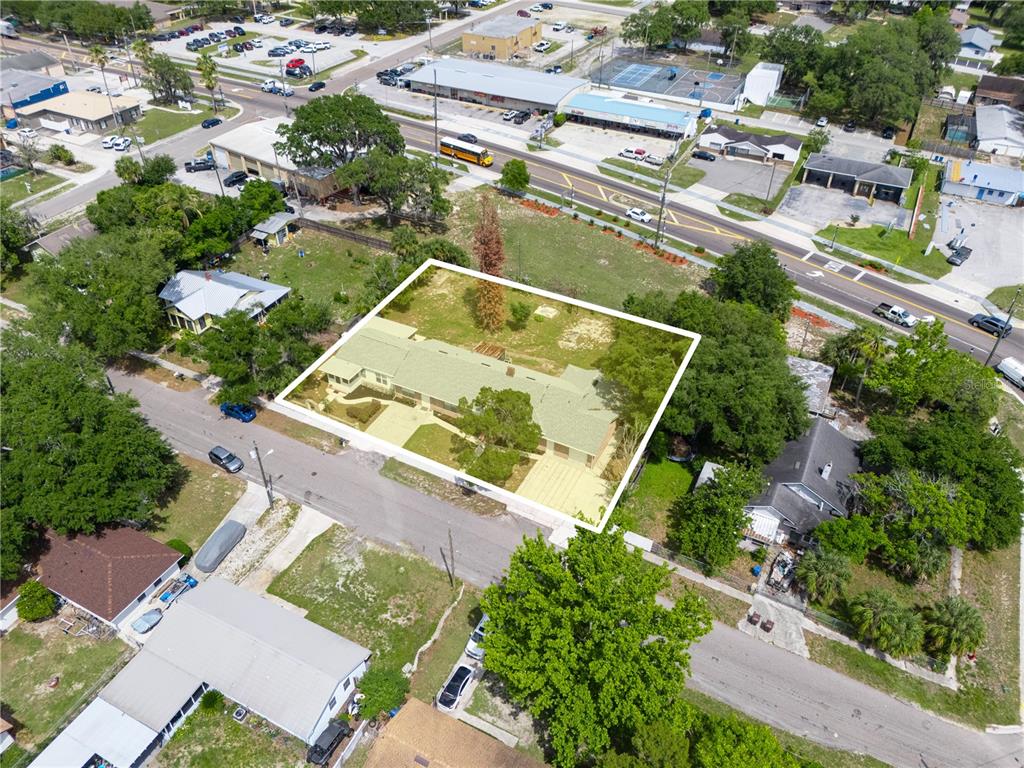 An aerial view shows a residential property highlighted by a white border on a lot — 221 CITRUS GROVE BOULEVARD S, POLK CITY, FL