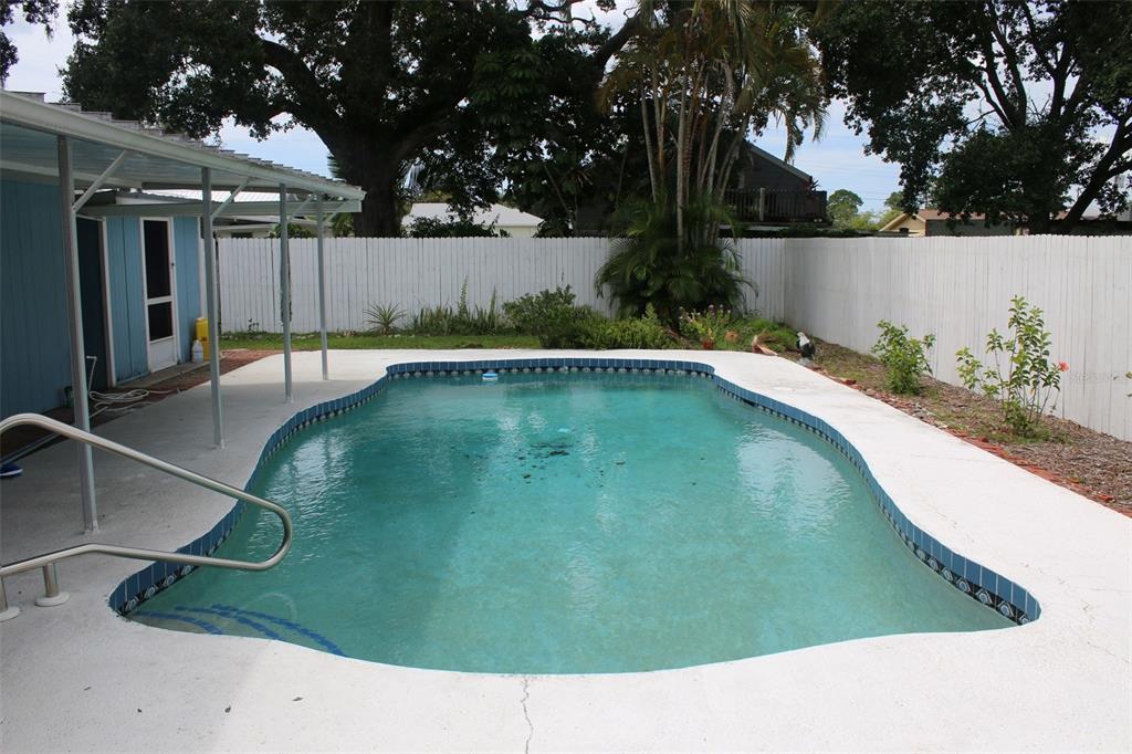 A backyard swimming pool with a concrete deck and a white privacy fence — 407 N POMPANO AVENUE, SARASOTA, FL