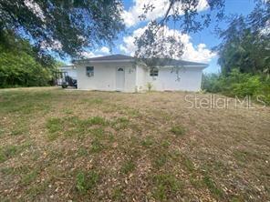 A single-story house with a blue front door, a two-car garage, and a manicured lawn — 3911 GEARY TERRACE, NORTH PORT, FL