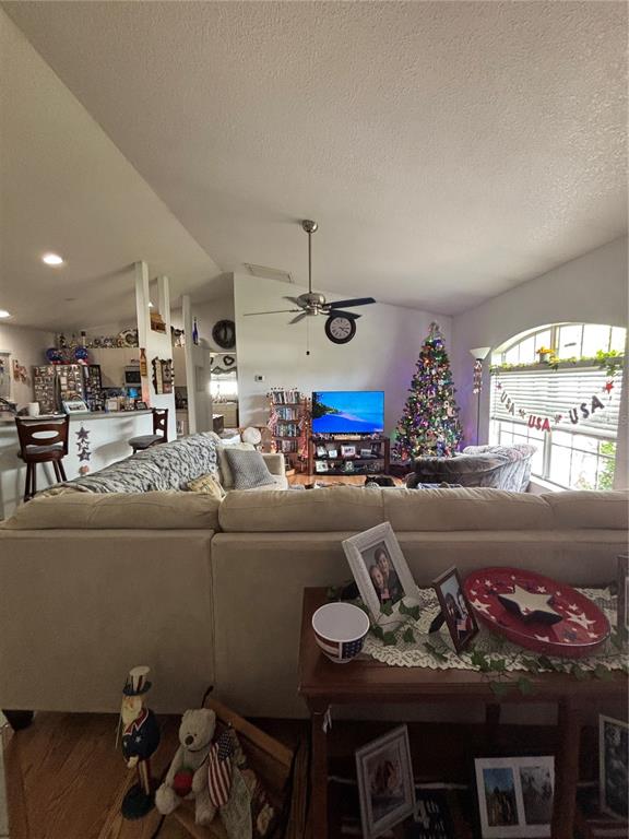 An open-concept living and dining area features tile flooring, a kitchen island, and bar seating — 3911 GEARY TERRACE, NORTH PORT, FL