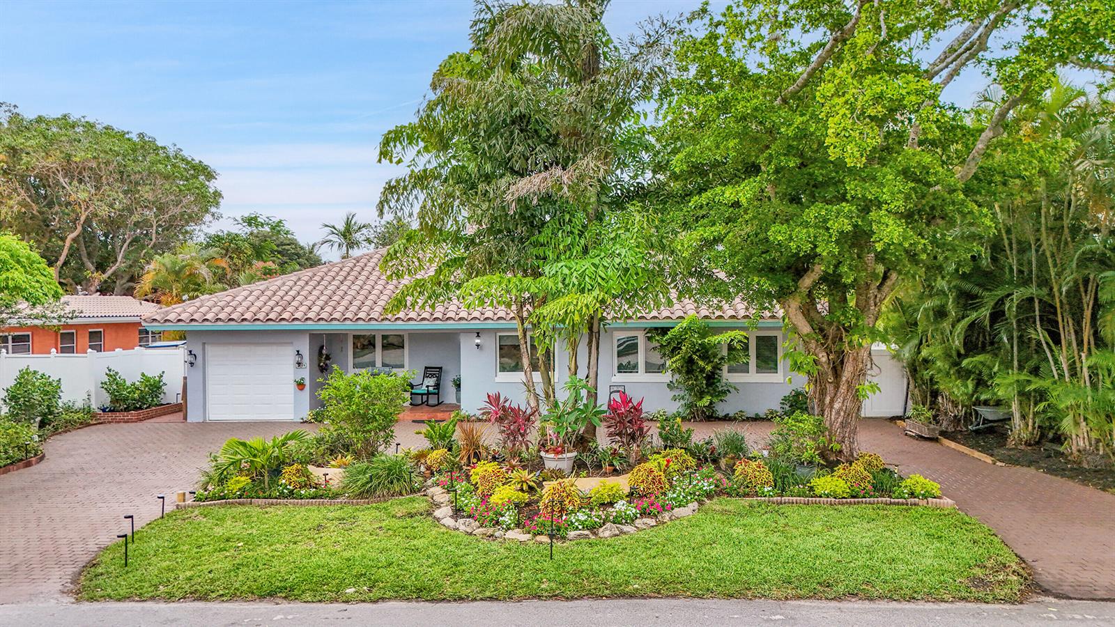 A single-story house with a tiled roof, a paved driveway, and a landscaped front yard — 3209 Norfolk Street, Pompano Beach FL 33062, POMPANO BEACH, FL