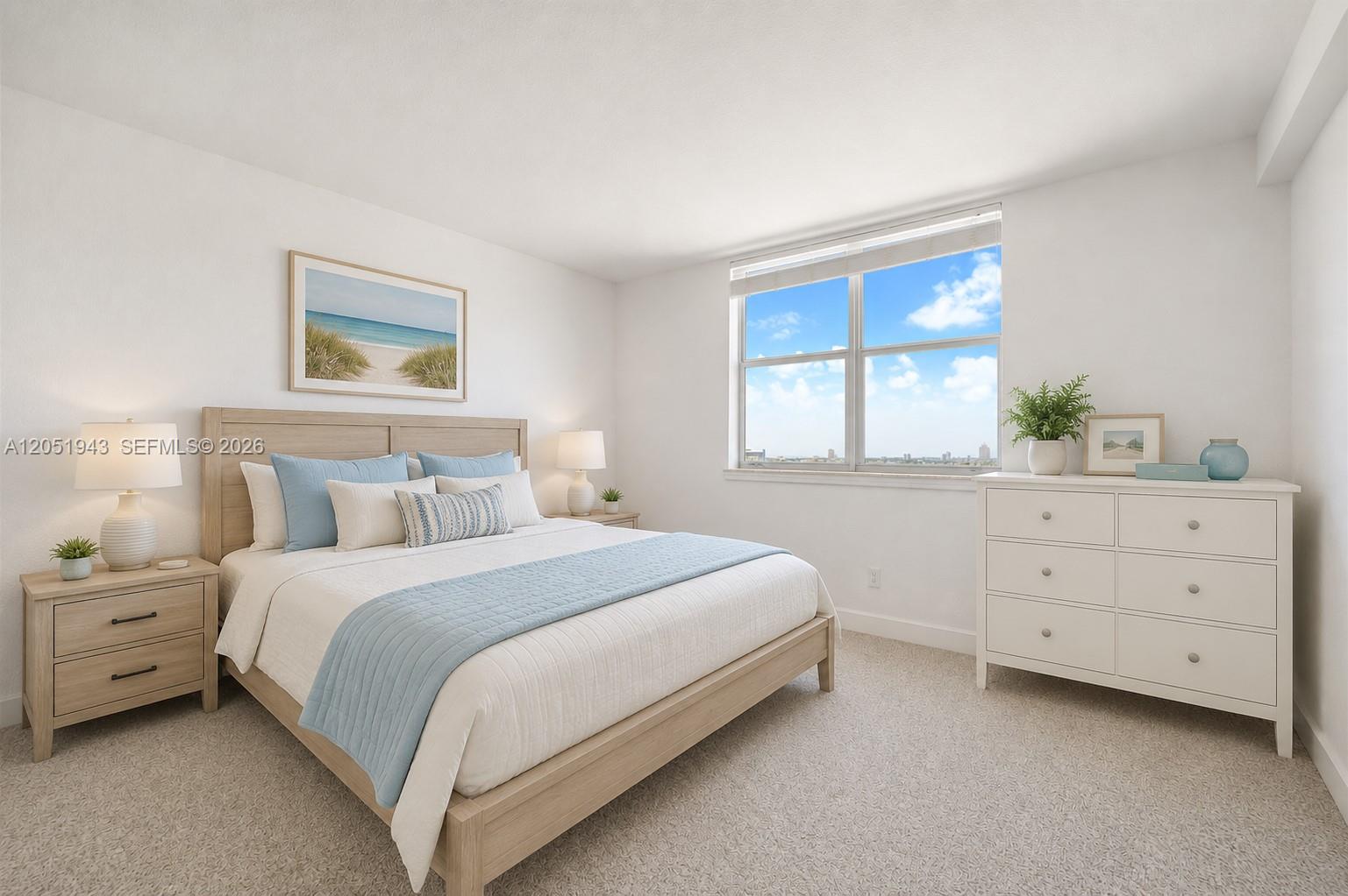 A bedroom features a light wood bed frame, white dresser, and a window with city views — 401 69th St # 1411, Miami Beach FL 33141, MIAMI BEACH, FL