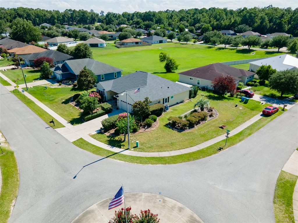 An aerial view shows a suburban neighborhood with houses, lawns, and a street intersection — 19346 NW 228TH STREET, HIGH SPRINGS, FL