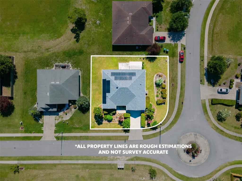 An aerial view shows a single-family house with solar panels on the roof — 19346 NW 228TH STREET, HIGH SPRINGS, FL