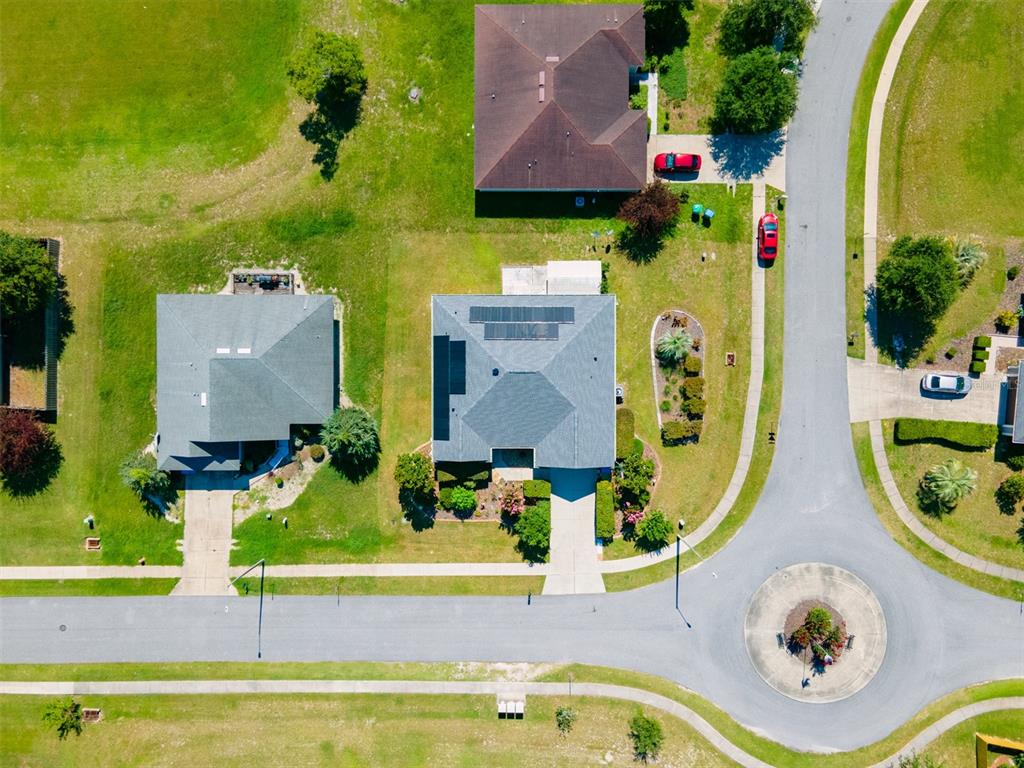 An aerial view shows two houses with gray roofs, one with solar panels, near a cul-de-sac — 19346 NW 228TH STREET, HIGH SPRINGS, FL