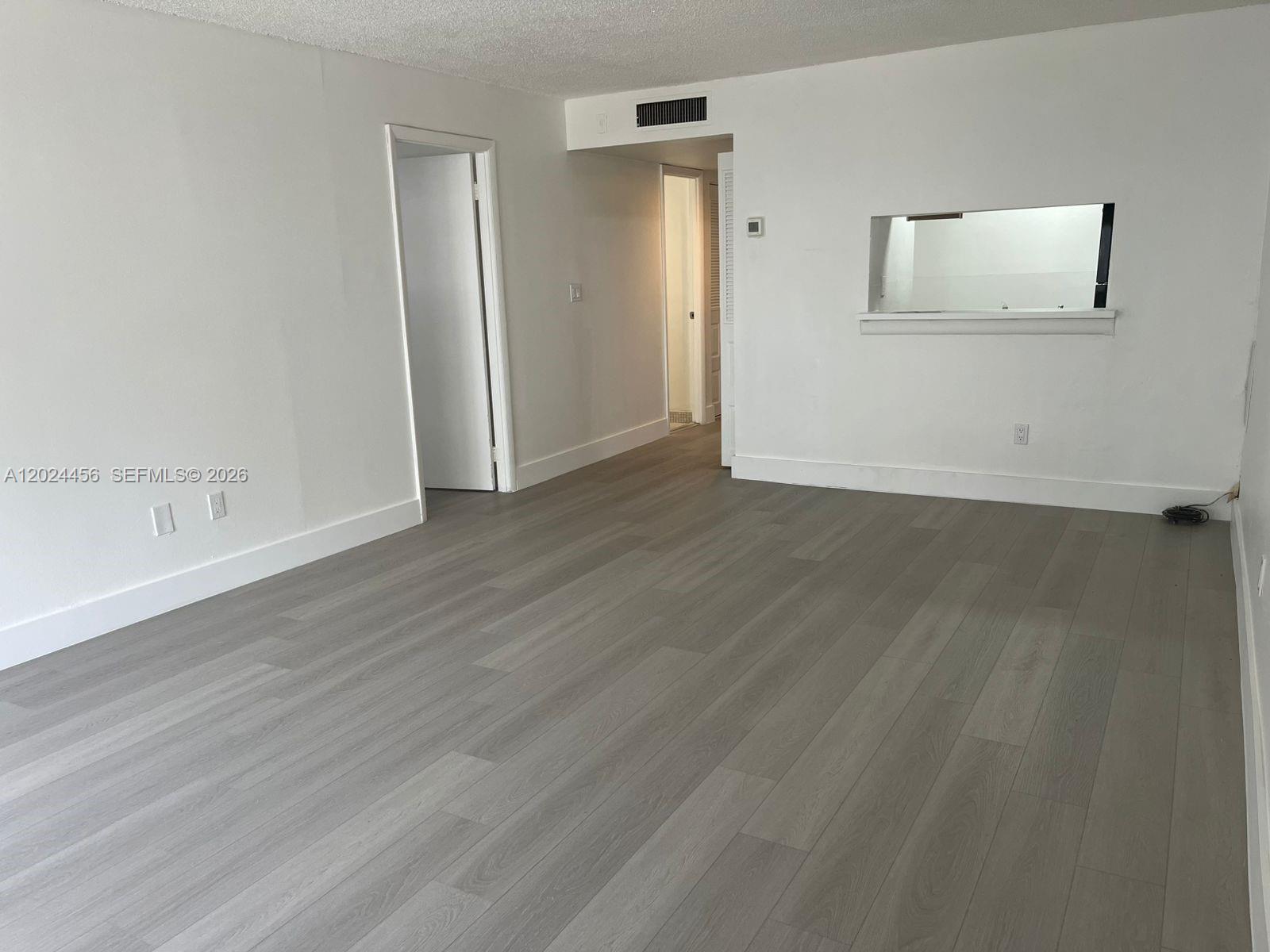 A bathroom features a white bathtub, a toilet, and a vanity with a sink — 484 NW 165th St Rd # 111, Miami FL 33169, MIAMI, FL