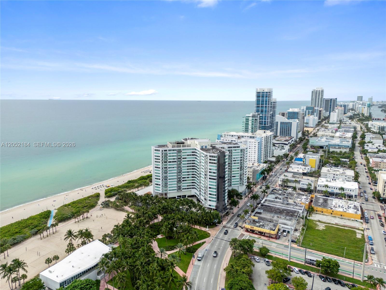 An aerial view shows a coastal city with high-rise buildings, a beach, and a road — 7135 Collins Ave # 1535, Miami Beach FL 33141, MIAMI BEACH, FL