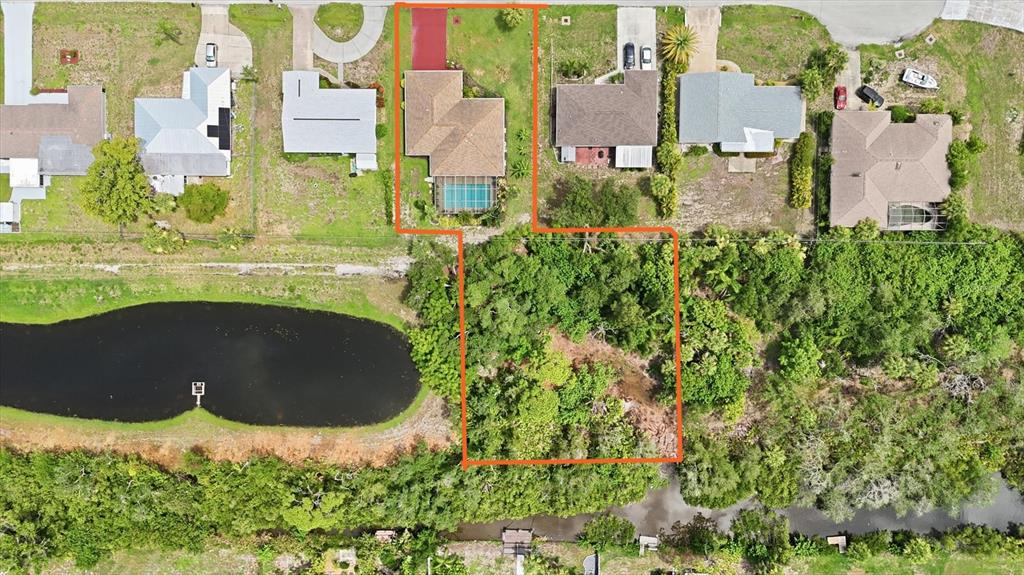 This aerial view shows a residential property with a house, pool, and large wooded lot — 383 E WENTWORTH CIRCLE, ENGLEWOOD, FL