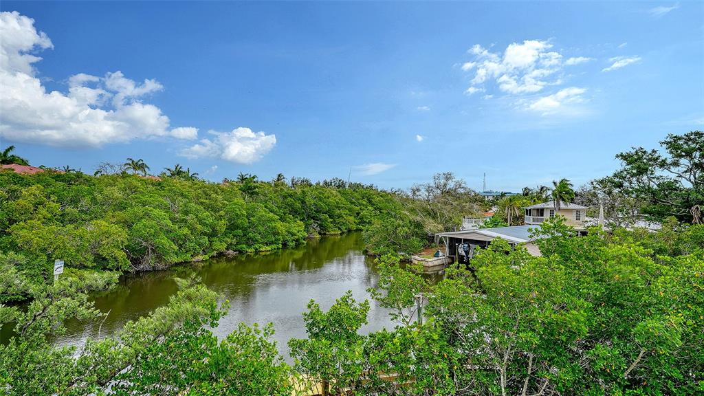 A view of a narrow waterway surrounded by dense green trees and a boat house — 4324 SALTWATER PEARL WAY, CORTEZ, FL
