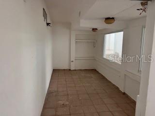 An empty room with white walls, tiled flooring, and a window overlooking the exterior — PR 1 Km 18.7 Int. SANCHEZ CAIMITO BAJO, SAN JUAN, PR