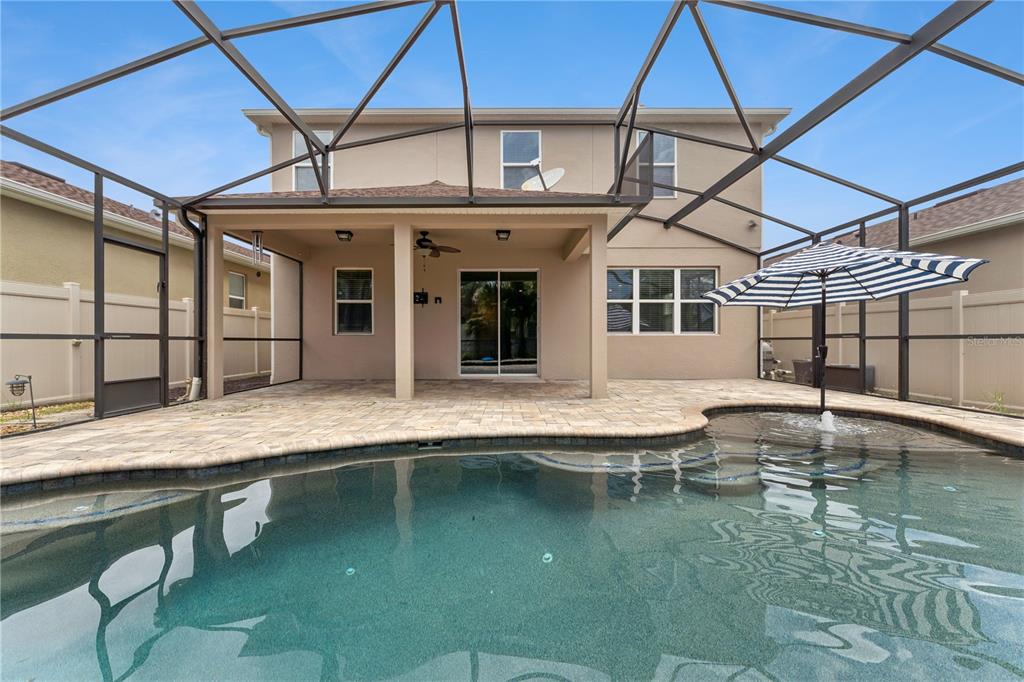 A two-story house with a screened-in patio, paver deck, and swimming pool — 4794 GRASSENDALE TERRACE, SANFORD, FL